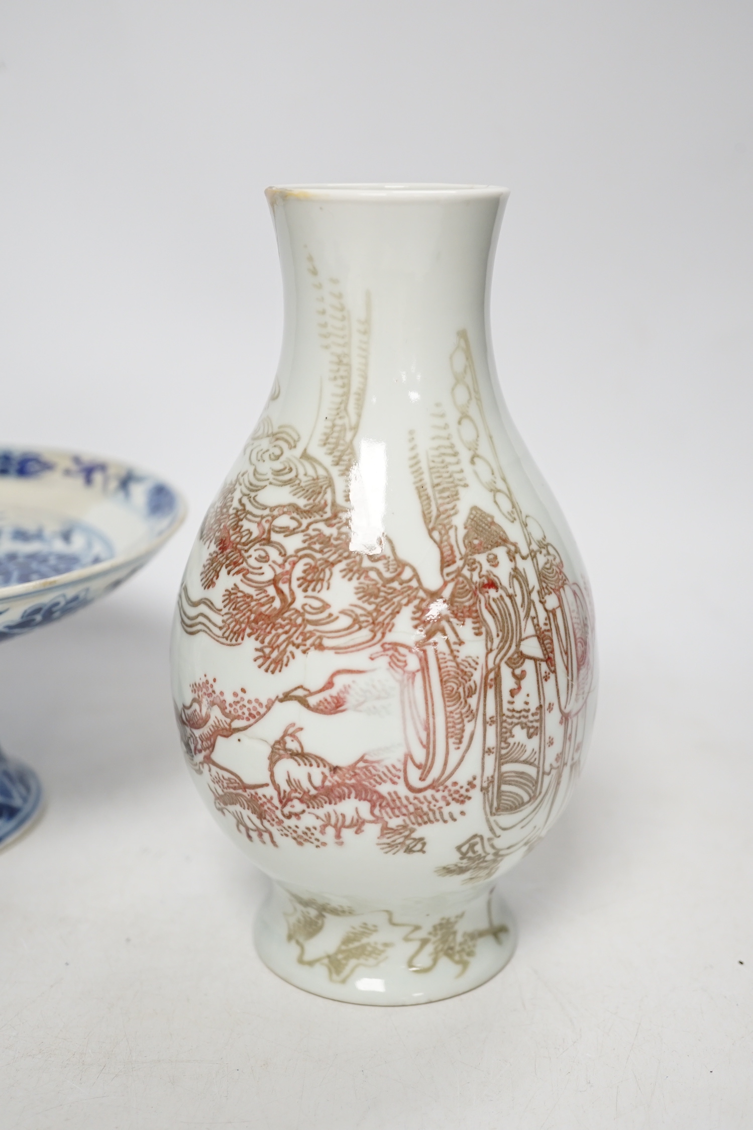 A Chinese underglaze copper red ‘herder and goats’ vase, Kangxi six character mark but Republic period and a Chinese blue and white lotus stem dish, six character Guangxu mark and period, both damaged